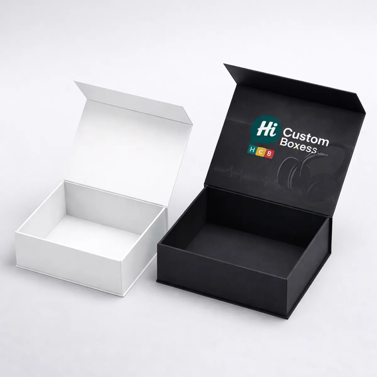 A white magnetic closure box next to a black luxury box with 